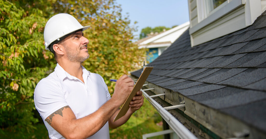 Man inspecting a roof
